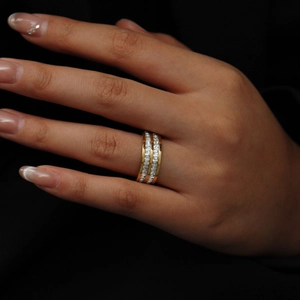 Close-up of double-row channel set crystals on a gold minimalist stainless steel ring