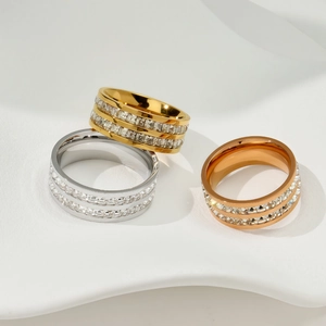 Detailed view of three rings in gold, silver and rose gold with double-row crystals