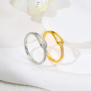 Macro shot of gold and silver U-shaped titanium rings with pavé cubic zirconia accents