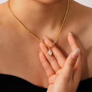 Detailed shot of a marquise-cut zircon pendant on a luxury gold titanium steel necklace