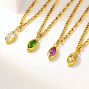 Macro detail of marquise cut zircon pendants in four colors with gold plated steel chains
