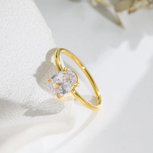 Elegant gold titanium steel ring with a sparkling oval-cut zircon and four-prong setting