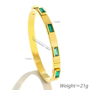 Gold stainless steel bangle with five emerald green rectangular gemstones and dimensions