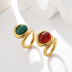 Detailed shot of vintage gold wide band rings with oval malachite and red onyx inlay