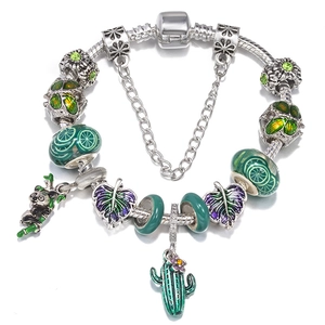 Silver snake chain bracelet with green cactus and panda charms on white background
