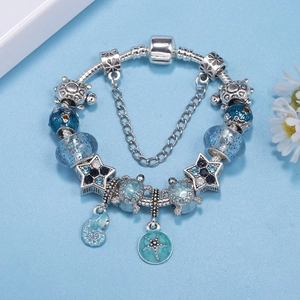 Silver ocean charm bracelet featuring blue glass beads, turtle and starfish pendants