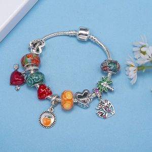 Silver snake chain charm bracelet featuring enamel strawberry and fruit pendants