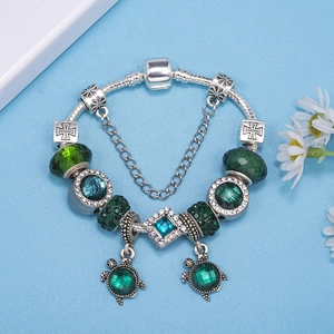 Silver snake chain bracelet with green crystal beads and cute turtle charms