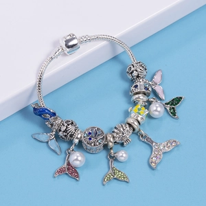 Ocean themed charm bracelet with mermaid tail and starfish pendants on snake chain