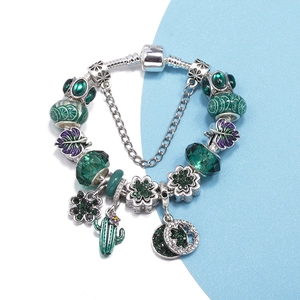 Fashion beaded charm bracelet with green crystals and purple leaf pendants on dual background