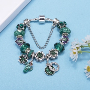DIY crystal beaded bracelet with green enamel charms and cactus pendants in forest green