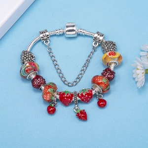 Silver snake chain bracelet featuring red enamel strawberry charms and glass fruit beads