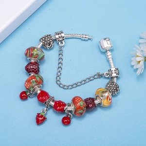Silver snake chain bracelet featuring strawberry charms and green fruit glass beads