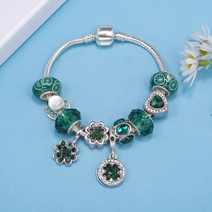Silver snake chain bracelet with emerald green crystal beads and clover charms