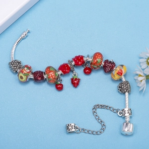 Silver snake chain bracelet with vibrant enamel fruit charms like strawberry and avocado