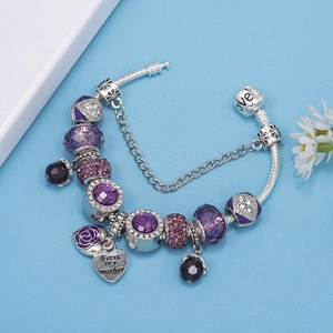 Detail of purple crystal beads and heart charm engraved with First my mother quote