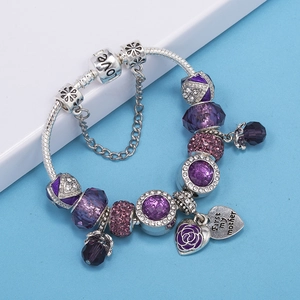 Detail of purple crystal beads and heart pendant with Love engraving on snake chain