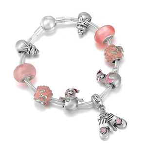 DIY Christmas charm bracelet featuring pink glass beads and winter snowman pendants