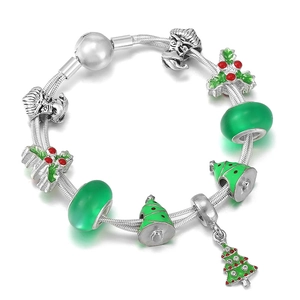 Silver Christmas bracelet featuring green tree charms and beads on white background