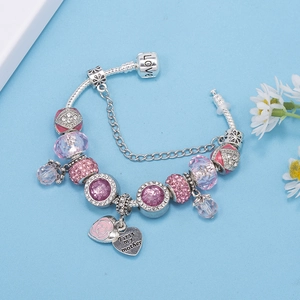Detail of beaded charm bracelet with rose heart pendant and purple crystal beads