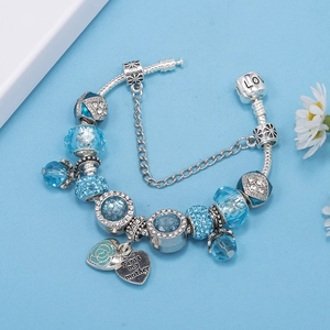 Detail of blue crystal beads and engraved heart pendant with First my mother text