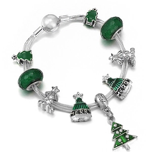 Macro view of Christmas charm bracelet with green enamel tree and merry hat beads