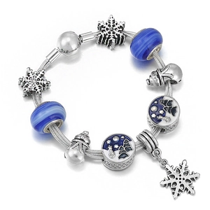 Winter snowflake charm bracelet with blue glass beads and silver snake chain base