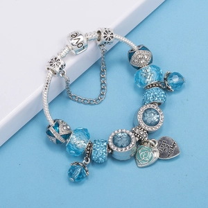 Detail of blue crystal charm bracelet featuring a rose heart pendant and love beads