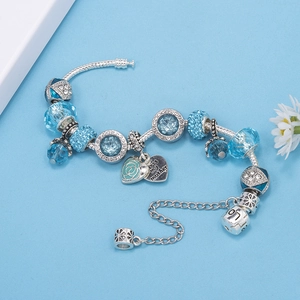 Detail view of blue crystal charm bracelet with silver heart and rose charms