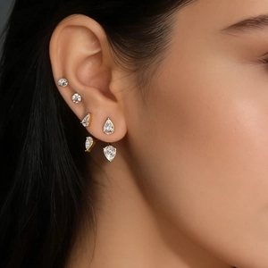 Detailed close-up of zircon earrings set in titanium steel on female model ear
