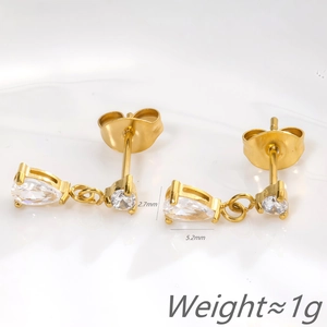 Detailed view of gold zircon studs showing 2.7mm and 5.2mm dimensions and 1g weight