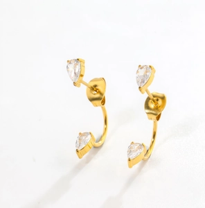 Detail of gold-plated stud earrings with pear-cut cubic zirconia in an elegant curved design
