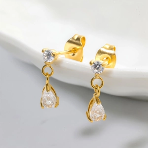 Elegant gold teardrop zircon stud earrings featuring pear-shaped stones and butterfly backs