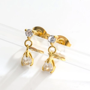 Detail of gold zircon earrings featuring round and teardrop crystals on acrylic stand