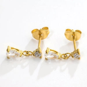 Detailed view of golden teardrop zircon earrings with butterfly back on white background