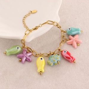Colorful sea life charm bracelet with gold starfish and tropical fish pendants