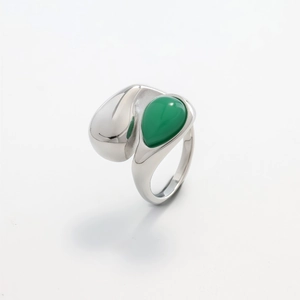 Detail view of water drop ring with green teardrop stone in polished steel