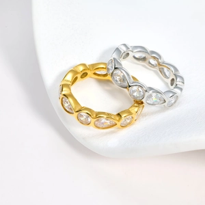Minimalist marquise-cut eternity rings in 18K gold and silver finishes on ceramic