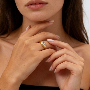 Macro shot of marquise-cut zircon set in a thick golden titanium steel ring