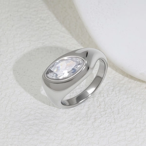 Detailed macro view of an oval-cut zircon set in a wide polished titanium steel ring