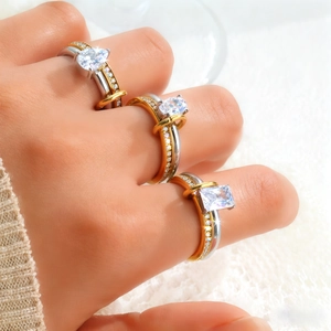 Fashionable stainless steel double rings with pear and oval cut crystals on model hand