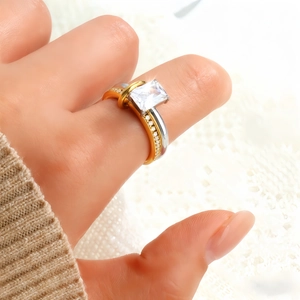Macro view of a bicolor stackable ring with large square-cut zirconia on a knit sweater