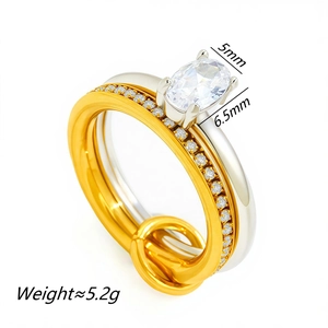 Detail of two-tone double ring set with 18K gold pave band and 6.5mm oval zircon