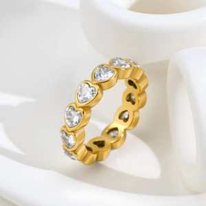 Macro view of gold plated heart-shaped cubic zirconia eternity ring on artistic stand