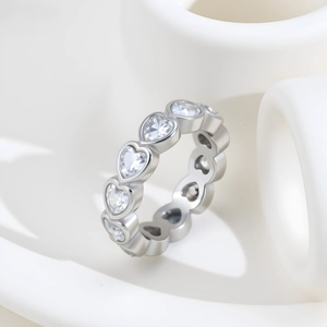Elegant silver heart-shaped eternity ring with cubic zirconia stones on white background