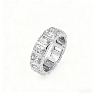 Macro shot of silver ring featuring rectangle-cut zircon stones and geometric metal band