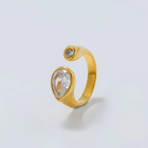 Detailed view of gold-plated open ring with pear-cut zircon and polished finish