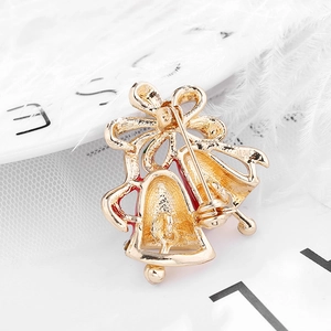 Back view of gold Christmas double bell napkin ring with pin clasp on white background