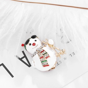 Fashionable Christmas snowman brooch with rhinestones and colorful scarf on white background