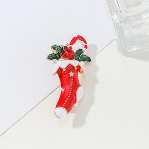 Christmas stocking brooch with candy cane and green holly leaves in enamel finish